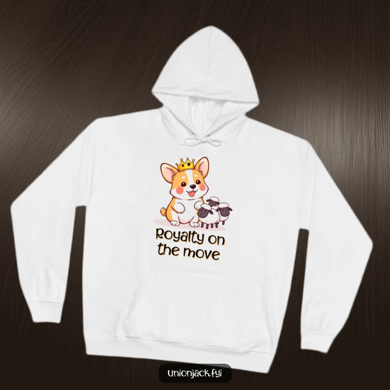 Funny hoodie showing a playful corgi in a miniature crown, comically attempting to herd sheep, for cozy laughs.