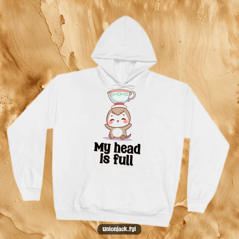 Funny hoodie displaying a smiling character performing an amusing teacup balancing feat, radiating joy and lighthearted fun.